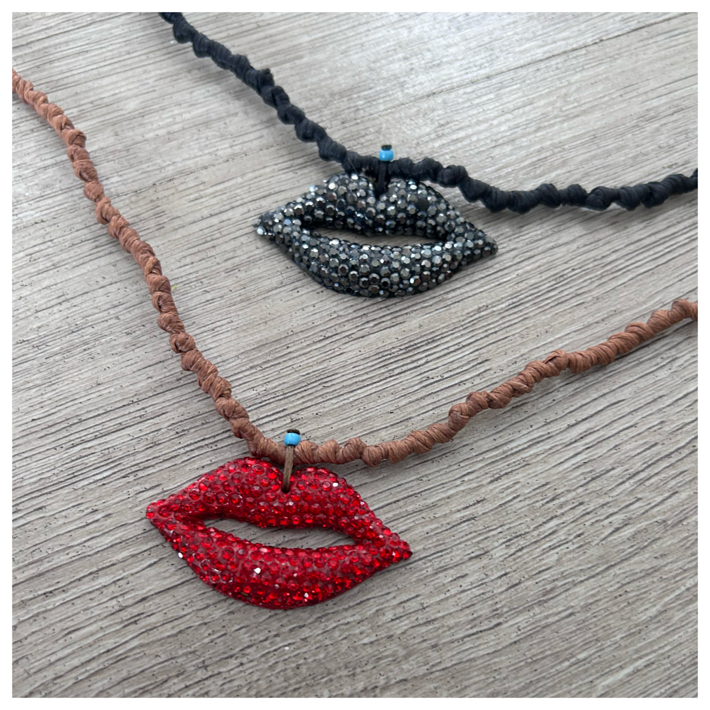 BLING “KISS” CHARM ON KNOTTED CORD