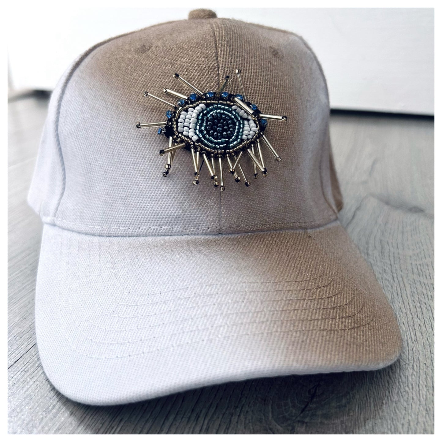 WHITE & GOLD CAP WITH EVIL EYE EMBELLISHMENT
