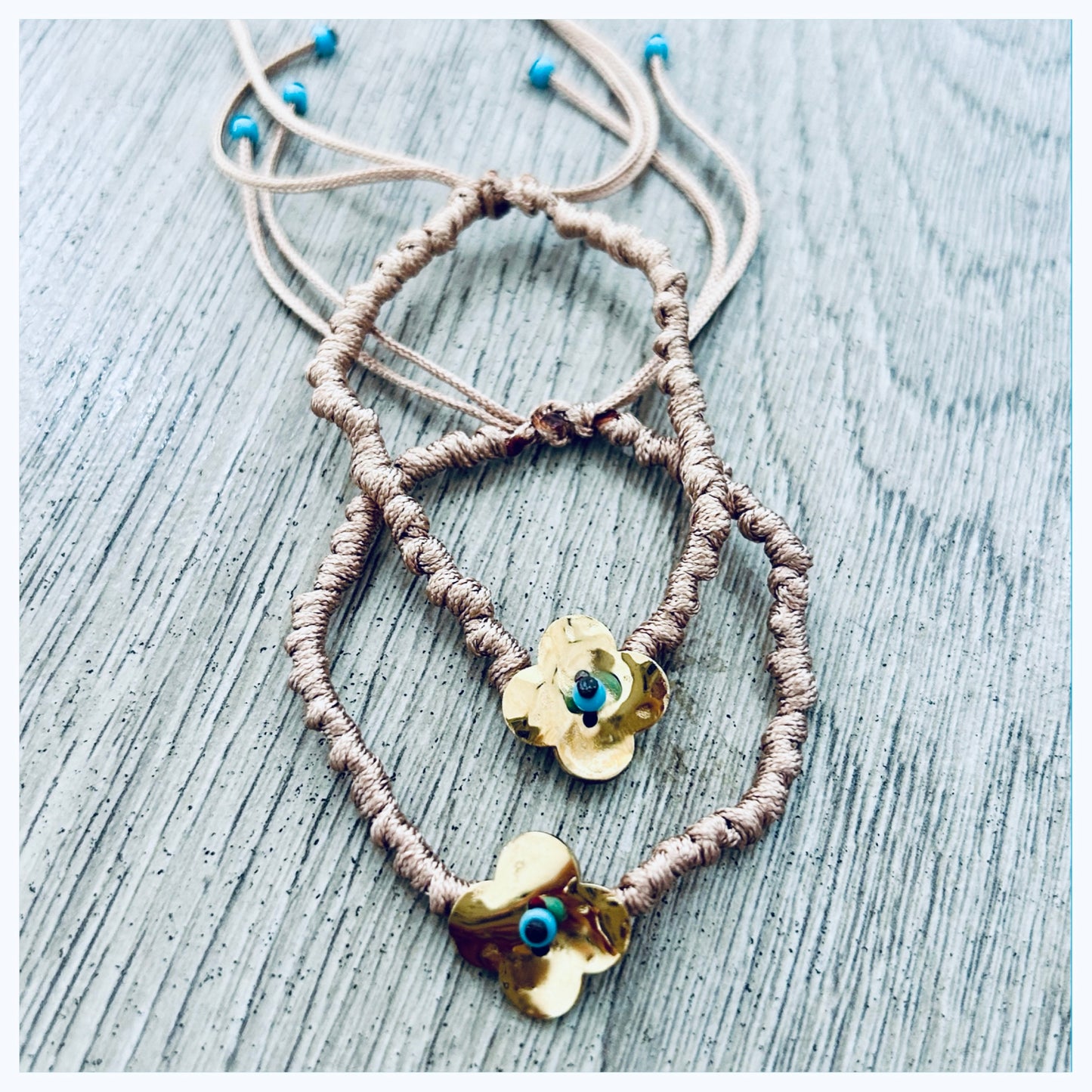 ADJUSTABLE KNOTTED CORD BRACELET WITH GOLD FLOWER DISC