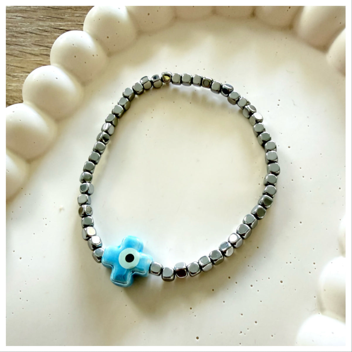 DARK SILVER HEMATITE BRACELET & CERAMIC EVIL EYE CROSS
